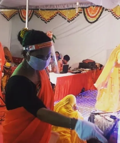 Our staff member, dressed in a traditional saree and following all safety protocols, serving at a Rajputana wedding. We respect and adapt to the cultural traditions of every event.