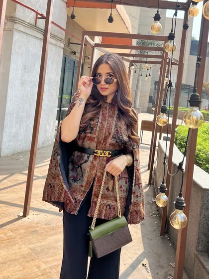 The details on this cape are just stunning. As a stylist, I'm always drawn to unique, handcrafted pieces that tell a story.