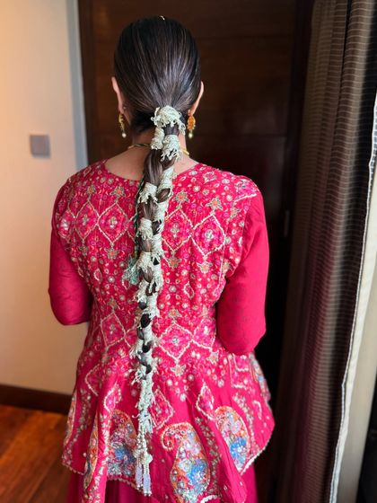 Gota in her braid and joy in her soul. This Mehendi look features a unique gota braid and clean, minimal makeup for a fresh and modern take on festive style.