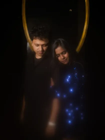 An artistic and moody portrait of the couple, using a mirror and soft focus to create a dreamy, intimate feel.