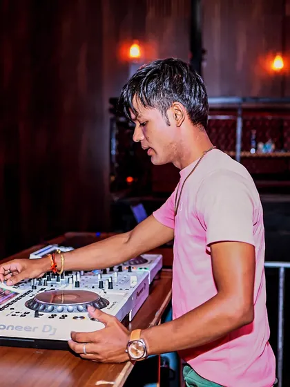 Capturing the energy of the room and amplifying it. A shot of me at a white Pioneer DJ console.