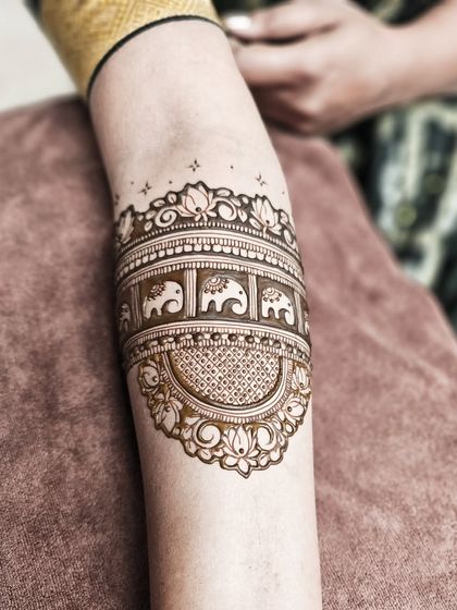 A close-up of the armband from this bridal set, featuring a parade of tiny, adorable elephants.