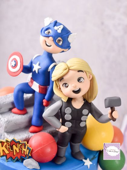 A close-up of the Captain America and Thor chibi-style figurines from the Avengers cake. Creating these cute, stylized versions of popular characters is one of my favorite things to do.