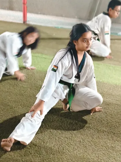 This student works on her lunge stretch, a key exercise for developing the hip flexibility needed for powerful roundhouse and side kicks.
