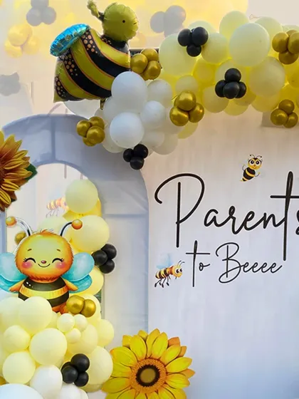 A close-up of our "Parents to Bee" baby shower backdrop. The elegant script, cute bee graphics, and sunflower details tie the whole theme together beautifully.