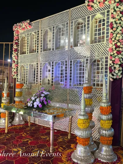 A beautiful backdrop inspired by traditional Rajasthani haveli architecture, complete with jharokhas and floral decorations.
