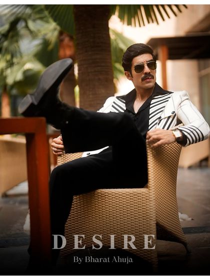 Kicking back in style. This relaxed pose shows the versatility of the pinstripe blazer, a piece that is as comfortable as it is commanding.