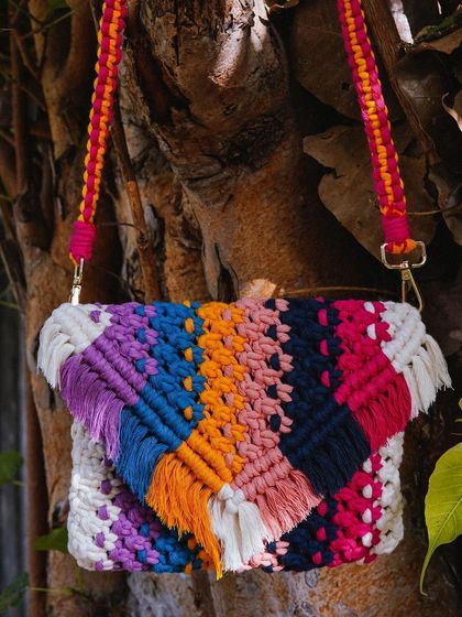 A full view of my 'Color Pop' macrame shoulder bag! This piece is a celebration of color, with a unique pattern woven from multiple vibrant threads. It's a true statement piece that's guaranteed to brighten up your wardrobe.
