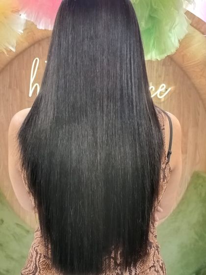 Another angle of the stunningly straight and shiny hair. This treatment combination is perfect for taming frizz and restoring hair health.