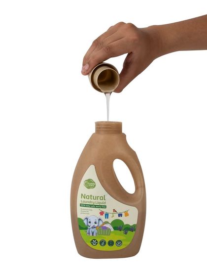 An action shot of pouring the laundry liquid, isolated on a white background.