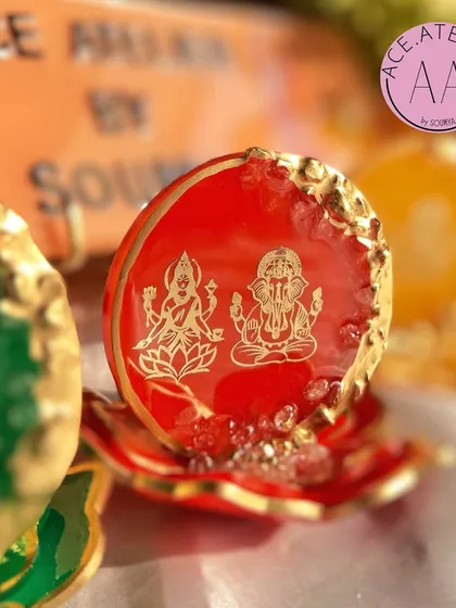 A detailed shot of the radiant red Lakshmi Ganesh standee. The deep red color symbolizes prosperity and is a traditional choice for festive decor.
