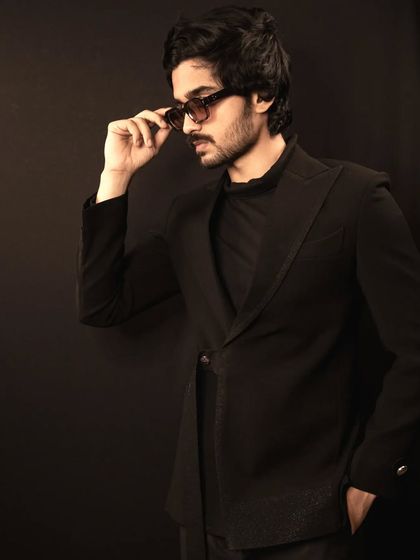 A model wearing the all-black suit, showing how it combines a modern aesthetic with classic tailoring for a look that is both stylish and sophisticated.