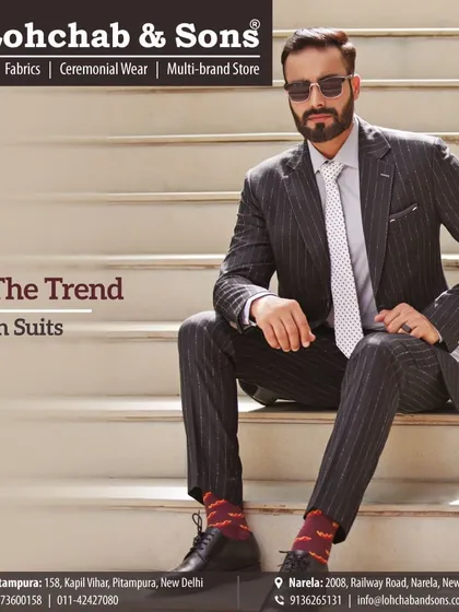 Set your own trend with a stylishly fitted pinstripe suit. The modern cut and sharp tailoring make this a standout piece, showing how classic patterns can be adapted for a contemporary look.