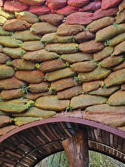 A closer look at the earthbag dome's texture. We used upcycled onion sacks filled with soil from the site and layered them with barbed wire acting as mortar. This ancient, low-cost method creates incredibly strong and beautiful structures.