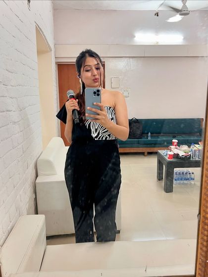 A mirror selfie in my green room, holding my mic, getting ready for a big show.