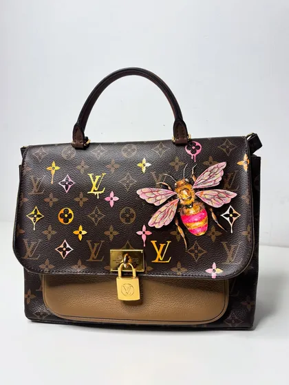 Here’s how I add a little color and quirk to a classic Louis Vuitton bag. This piece features a vibrant, hand-painted bee and colorful LV monograms. It’s all about taking something you love and making it uniquely yours.