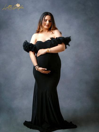 This off-the-shoulder black gown with ruffled sleeves is a stunning choice for a classic maternity portrait. It’s simple, elegant, and all about you.
