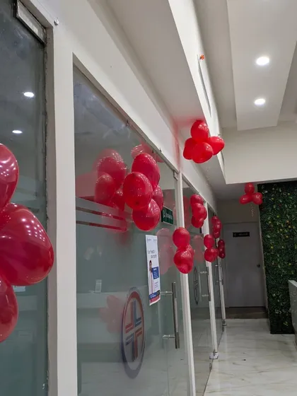 A view down the clinic's corridor, showing how simple balloon clusters attached to the walls and ceiling can effectively carry a theme throughout a space.