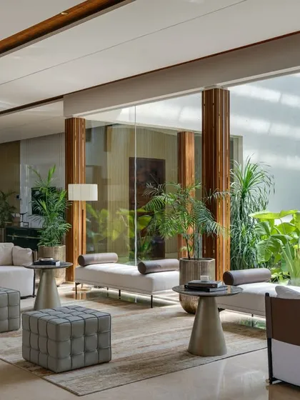 In our Celadon farmhouse project, the formal living area flows effortlessly into a central lounge and an open-air courtyard. This design choice maximizes natural light and fosters a constant connection to the lush greenery, embodying our principle of blurring the lines between inside and out.
