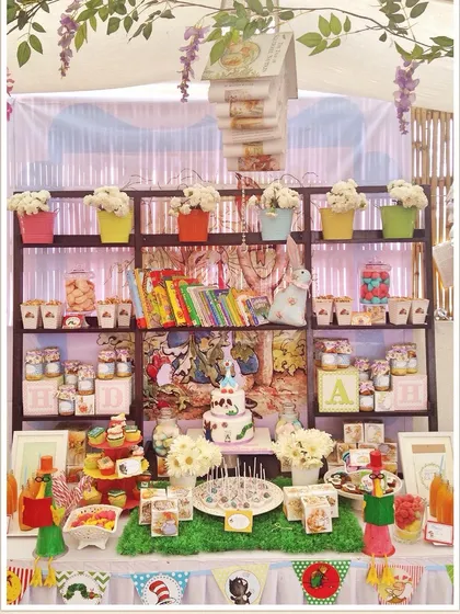 A unique "book library" themed baby shower. The dessert table was designed as a bookshelf filled with classic children's books and themed treats.
