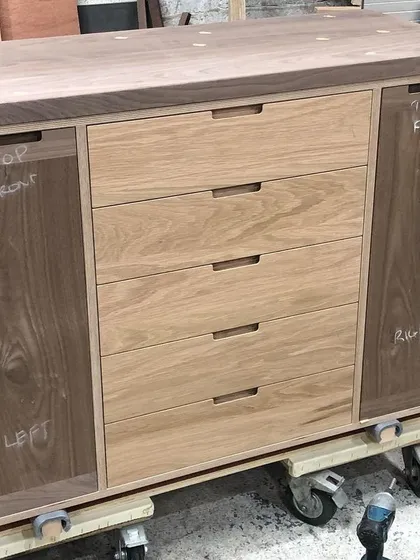 Here is the lower section of the drinks cabinet in my workshop before installation. You can see the solid wood construction, with oak drawer fronts and walnut cabinet doors, built upon a robust birch plywood frame.