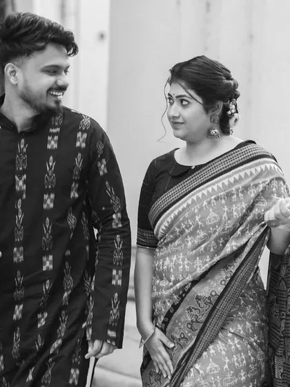 A candid black and white shot of the couple walking and talking. Their natural interaction and expressions showcase the authentic, documentary style I bring to heritage shoots.