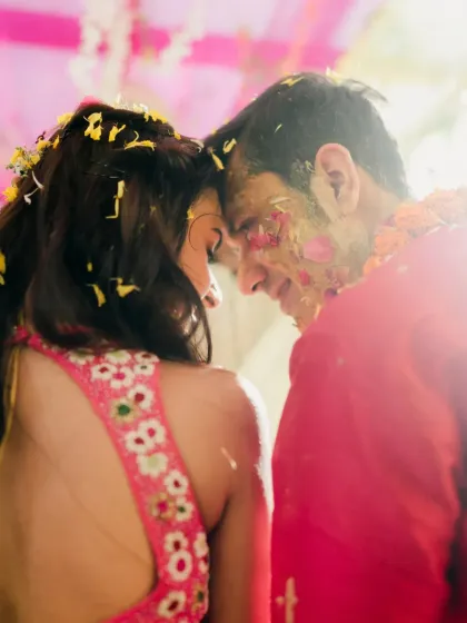 An intimate, sun-kissed moment between the couple during their Haldi. The soft light and close framing create a romantic and dreamy feel.