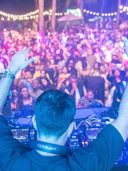 Another view from behind the decks in Mauritius, with my hands up, mirroring the energy of the thousands of fans in front of me. This connection is what live music is all about.