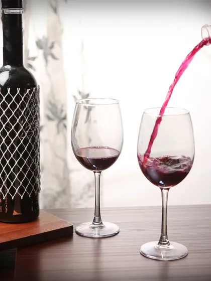 We excel at capturing dynamic action shots that bring beverages to life. This photograph freezes the moment of red wine being poured, highlighting the liquid's color and motion, a technique that adds energy and appeal to product listings and promotional materials.