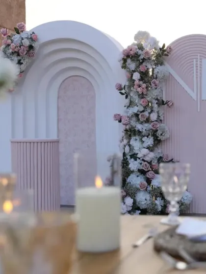 This Roka ceremony backdrop features modern arches, a soft pastel color palette, and a custom "NK" monogram for the couple. It’s a perfect example of a contemporary and elegant setup for a sundowner engagement event.