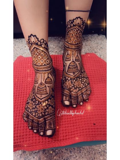 Beautifully detailed bridal feet mehendi, featuring jhumka (traditional earring) motifs and delicate floral patterns.