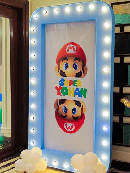 Another view of the personalized "Super Yohan" marquee sign. The bright lights and custom graphics create an exciting entrance for a video game-themed party.