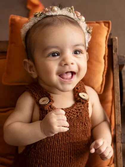 A close-up of the baby's joyful expression during her 3-month session.