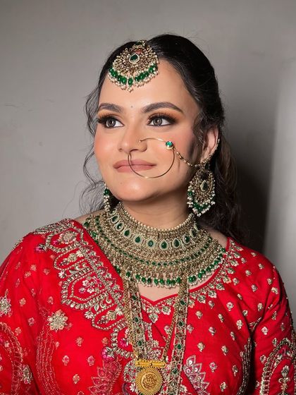 A radiant and red vision of bridal beauty. We kept her base clean and played up the eyes with a soft mauve lip to balance the boldness.