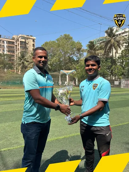 A moment of welcome as our coach presents a bouquet to the Technical Director of SESA Football Academy.
