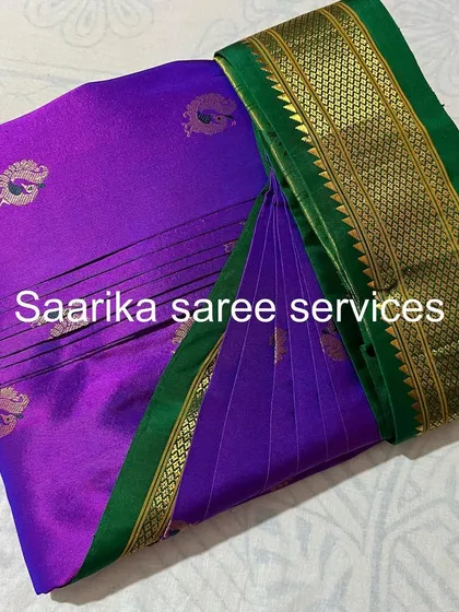 A bright purple saree with a traditional Paithani-style border.