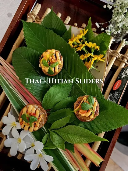 Our Thai-Haitian sliders, beautifully presented on fresh leaves and flowers for a tropical feel.