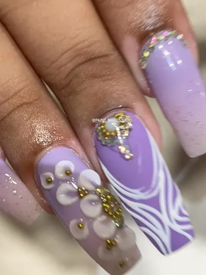 A macro shot of the detailed Diwali nail art. You can see the delicate 3D flowers, the precise line work, and the careful placement of each crystal.