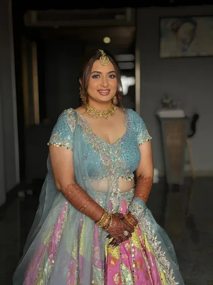 A happy bride-to-be at her Haldi ceremony. Dhruvi's makeup is kept light and radiant, allowing her natural glow to shine through.