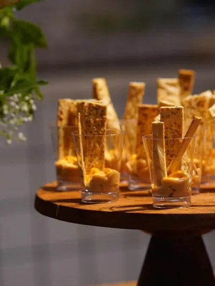 Crispy mathri sticks served with a creamy hummus dip in individual portions. It's a modern twist on a classic snack, perfect for mingling.