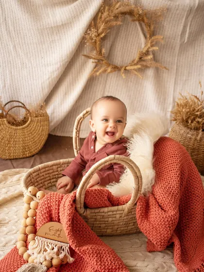 Look at that happy smile. Sitter sessions, for babies who can sit up on their own, are full of personality. I use simple, rustic props like this wicker basket to keep the focus on your baby's expressions.