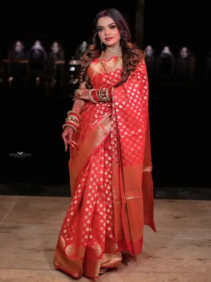 A classic full-length pose, capturing the timeless beauty of the traditional attire.