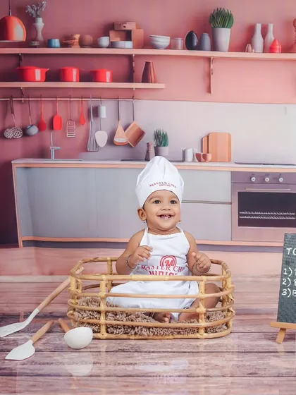 This little chef is ready for his close-up. The warm lighting and colorful props make this a very inviting scene.