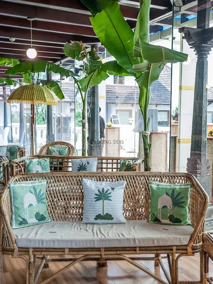 A comfortable and stylish lounge area for a Haldi. We used cane sofas with custom-printed cushions, surrounded by banana plants, to create a relaxed, tropical vibe.