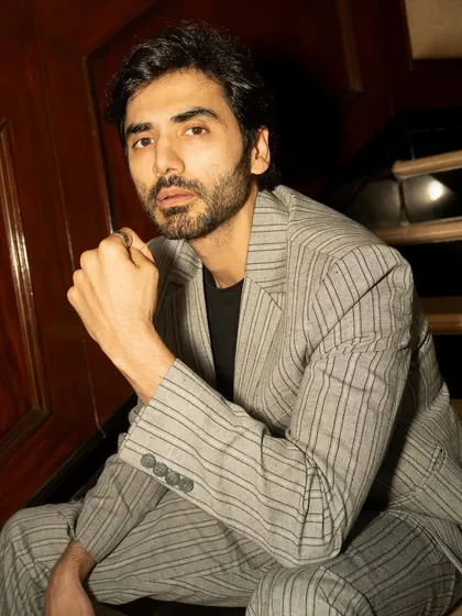 A close-up portrait of Ishwak Singh for GQ. The tight crop and direct gaze create an intimate and powerful image, perfect for an actor's feature.