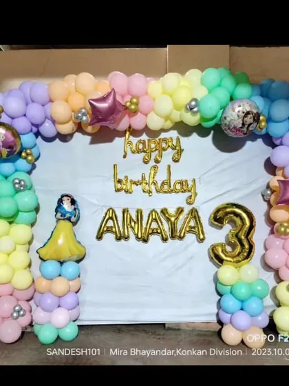 A colorful pastel balloon arch for a 3rd birthday. This home setup includes foil balloons for the name and age, with a Snow White cutout adding a touch of princess magic.