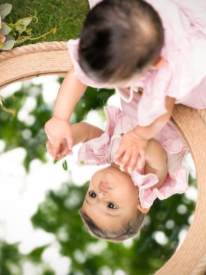 Another angle of the mirror shot, showing the baby's curiosity and the beautiful reflection of the sky and trees.