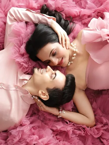 A quiet moment of connection before two become three. This overhead shot, surrounded by a sea of soft pink tulle, is one of my favorite creative poses for capturing romance.