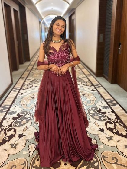 This client is all smiles in a flowing maroon gown with a beautifully embellished bodice. It’s a comfortable yet glamorous rental option for an evening party or reception.