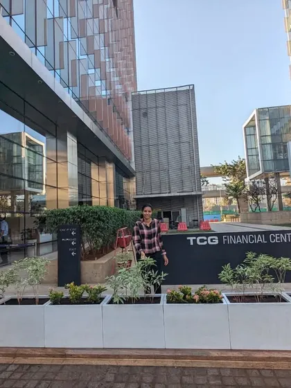 Here is the finished installation at the TCG Financial Centre in BKC, Mumbai. The clean lines of the light-colored, rectangular FRP planters create a modern and welcoming entrance, filled with a mix of Variegated Tagar and Ixora plants that add texture and color.